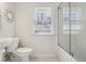 Bright bathroom with a glass-enclosed shower, modern fixtures, and a stylish mosaic tile floor at 1431 S Glencoe St, Denver, CO 80222