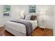 Serene bedroom with natural light, hardwood floors, and neutral decor creating a peaceful atmosphere at 1431 S Glencoe St, Denver, CO 80222