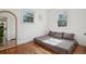 Cozy bedroom featuring hardwood floors, comfortable bedding, and dual windows for ample natural light at 1431 S Glencoe St, Denver, CO 80222