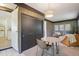 Small dining area next to living room with a round table, chairs, and sliding closet doors at 1431 S Glencoe St, Denver, CO 80222