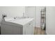 Functional laundry room equipped with modern washer and dryer units and shelving for storage at 1431 S Glencoe St, Denver, CO 80222