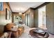 Relaxing living room with outdoor views, leather sofa, wood paneled walls and sliding doors at 1431 S Glencoe St, Denver, CO 80222