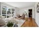 Bright living room with hardwood floors, large windows, and stylish decor at 1431 S Glencoe St, Denver, CO 80222