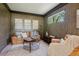 Inviting living room with wood paneled walls, leather seating, and natural light from the window at 1431 S Glencoe St, Denver, CO 80222