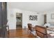 View of the living room with hardwood floors and stylish decor leading into the kitchen at 1431 S Glencoe St, Denver, CO 80222