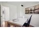 Bright office space featuring a modern desk and chair, complemented by stylish decor and artwork at 1431 S Glencoe St, Denver, CO 80222