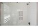 Modern shower with white subway tiles, glass door, and built-in shelving niche at 1431 S Glencoe St, Denver, CO 80222