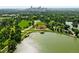 Beautiful aerial view of the park with a lake and boat house in front of the Denver skyline at 1582 Steele St, Denver, CO 80206