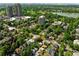 Picturesque aerial shot of a residential neighborhood with mature trees, and a nearby lake at 1582 Steele St, Denver, CO 80206