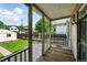 Covered back porch features wood decking overlooking a grassy yard with a detached garage at 1582 Steele St, Denver, CO 80206