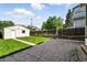 Spacious backyard featuring a stone paver patio, a well-maintained lawn, and a detached garage at 1582 Steele St, Denver, CO 80206