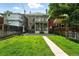 Expansive backyard features a large grassy area, a stone paver patio, and a traditional two-story house at 1582 Steele St, Denver, CO 80206