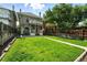 Large grassy backyard with a stone paver patio and walkway, along with a charming two-story home at 1582 Steele St, Denver, CO 80206