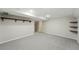 Open basement with neutral carpet and accent shelves at 1582 Steele St, Denver, CO 80206