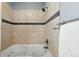 Bathroom showcasing tiled shower over tub with chrome fixtures and towel rack at 1582 Steele St, Denver, CO 80206