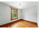 Bedroom showcasing hardwood floors and stained glass window with view at 1582 Steele St, Denver, CO 80206