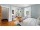 Tranquil bedroom with light blue walls, hardwood floors, and natural light from a window at 1582 Steele St, Denver, CO 80206