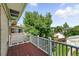 Exterior view of a wood deck and white railing with tree view at 1582 Steele St, Denver, CO 80206