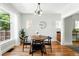 Charming dining room featuring hardwood floors, a modern light fixture and ample sunlight at 1582 Steele St, Denver, CO 80206