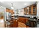 Spacious kitchen with stainless steel appliances, granite countertops, and wood cabinetry at 1582 Steele St, Denver, CO 80206