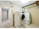 Well-lit laundry room with a modern Samsung washer and dryer on pedestals and tiled floors at 1582 Steele St, Denver, CO 80206