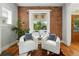 Inviting living room features a brick wall, fireplace and cozy seating at 1582 Steele St, Denver, CO 80206