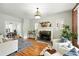 Bright living room featuring a fireplace, hardwood floors, and ample natural light at 1582 Steele St, Denver, CO 80206