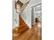 Elegant staircase with white railings and hardwood steps leading to the upper level at 1582 Steele St, Denver, CO 80206