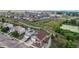 Aerial view of houses and homes in a suburban neighborhood next to a large grassy area and a pond at 169 Westin Ave, Brighton, CO 80603