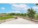 A fenced backyard with a fire pit, patio area, and a view of the surrounding greenery at 169 Westin Ave, Brighton, CO 80603