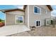 Exterior showcasing a sliding glass door and a concrete patio overlooking the yard at 169 Westin Ave, Brighton, CO 80603