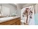 Cozy bathroom features a vanity with countertop and a shower with a decorative curtain at 169 Westin Ave, Brighton, CO 80603