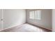 A bright bedroom showcases a window providing natural light, carpeted floors, and neutral paint at 169 Westin Ave, Brighton, CO 80603