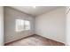 A bright bedroom showcases a window providing natural light and carpeted floors at 169 Westin Ave, Brighton, CO 80603