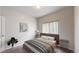 Stylized bedroom features a neutral palette, plush bedding, and ample natural light from a bright window at 169 Westin Ave, Brighton, CO 80603