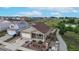 Aerial view of a tan two-story home with a two-car garage, a front yard garden, and a covered front porch at 169 Westin Ave, Brighton, CO 80603