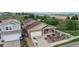 Aerial view of a tan two-story home with a two-car garage, a front yard garden, and a covered front porch at 169 Westin Ave, Brighton, CO 80603