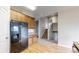 Well-designed kitchen showing hardwood flooring, granite countertops, and modern appliances with an open floor plan at 169 Westin Ave, Brighton, CO 80603