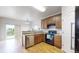 A modern kitchen with wood cabinets, stainless steel appliances, and an open floor plan to dining area at 169 Westin Ave, Brighton, CO 80603