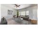 Bright living room offering neutral decor, a ceiling fan, and floods of natural light from a large window at 169 Westin Ave, Brighton, CO 80603