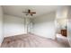 Spacious main bedroom with neutral paint, ceiling fan, and ensuite bathroom access, offering a private retreat at 169 Westin Ave, Brighton, CO 80603