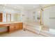 Luxurious bathroom featuring a soaking tub, vanity, and separate shower at 15916 E Crestridge Pl, Centennial, CO 80015