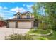 Charming two-story home with a brick facade and attached two-car garage at 15916 E Crestridge Pl, Centennial, CO 80015