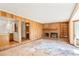 Cozy living room featuring a brick fireplace and access to the kitchen and bathroom at 15916 E Crestridge Pl, Centennial, CO 80015