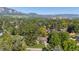 Scenic aerial view of the property showcases its location among lush greenery with mountain views at 255 Kiowa Pl, Boulder, CO 80303