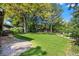 Spacious backyard with lush green lawn, mature trees, and a stepping stone pathway at 255 Kiowa Pl, Boulder, CO 80303