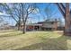 Spacious backyard with lush lawn, mature trees, and an inviting covered patio for outdoor enjoyment at 255 Kiowa Pl, Boulder, CO 80303