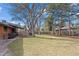 Expansive backyard featuring mature trees, a well-maintained lawn, and a cozy outdoor dining area at 255 Kiowa Pl, Boulder, CO 80303