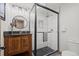 Updated bathroom with sleek vanity, round mirror, and walk-in shower featuring patterned tile and glass enclosure at 255 Kiowa Pl, Boulder, CO 80303