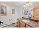 Bathroom featuring granite countertop, wood vanity, and arched-panel door in warm tones at 255 Kiowa Pl, Boulder, CO 80303